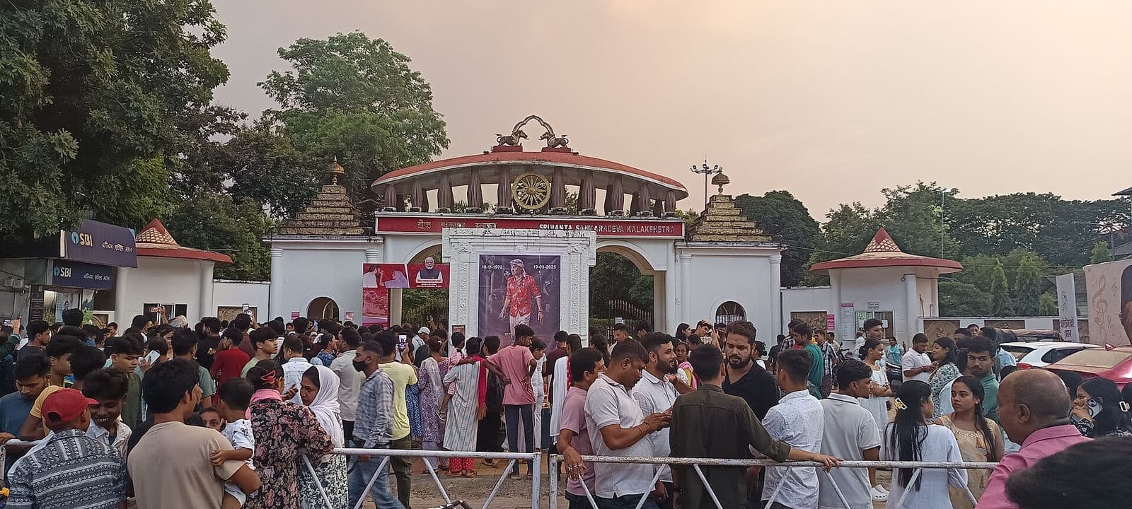 Crowds gathered before a large portrait of Zubeen Garg at Sankardev Kalakhetra, Guwahati