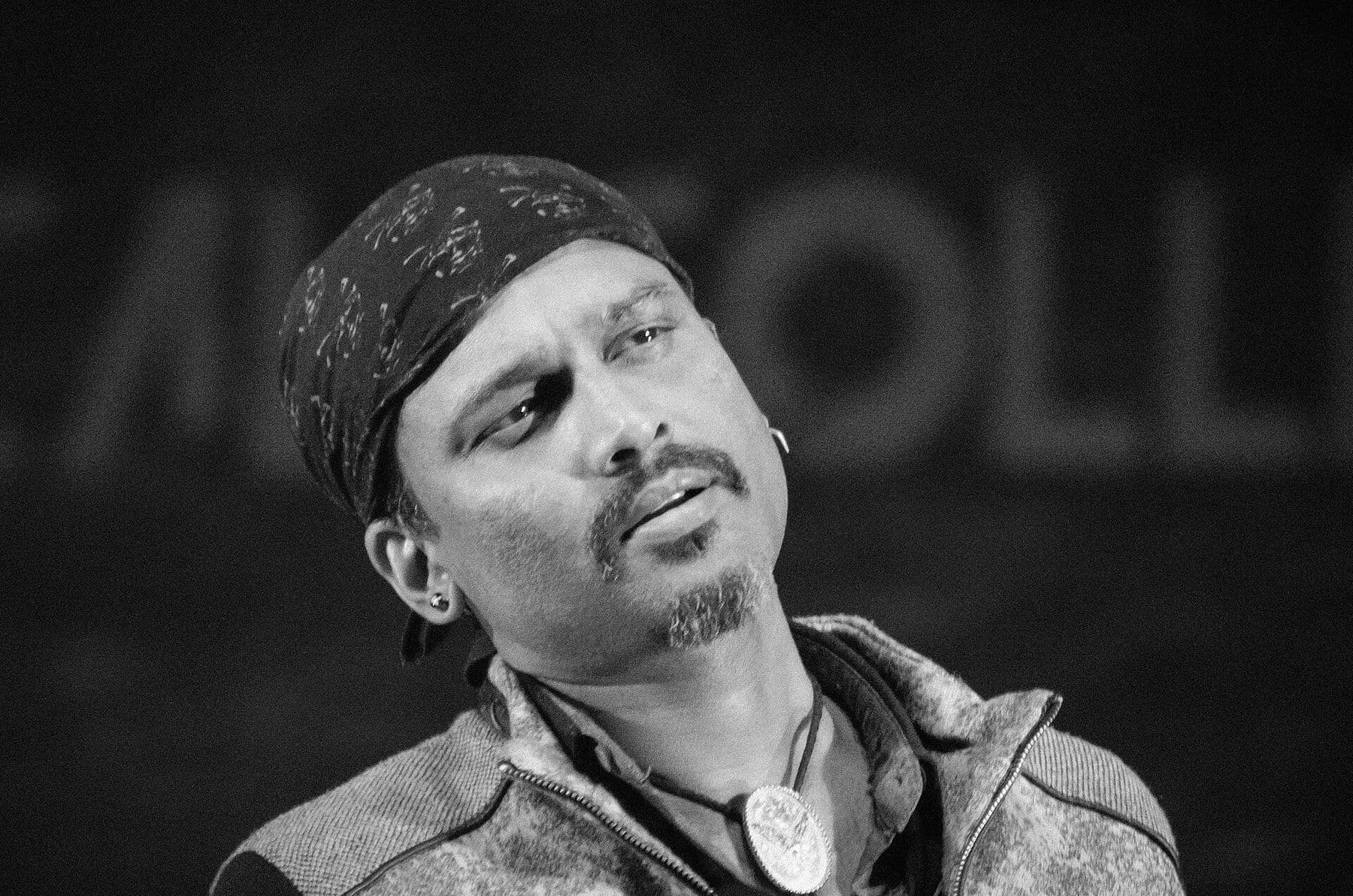 Zubeen Garg singing into a microphone, black and white close portrait, Guwahati 2016